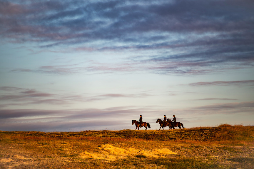 People riding horses in Iceland.